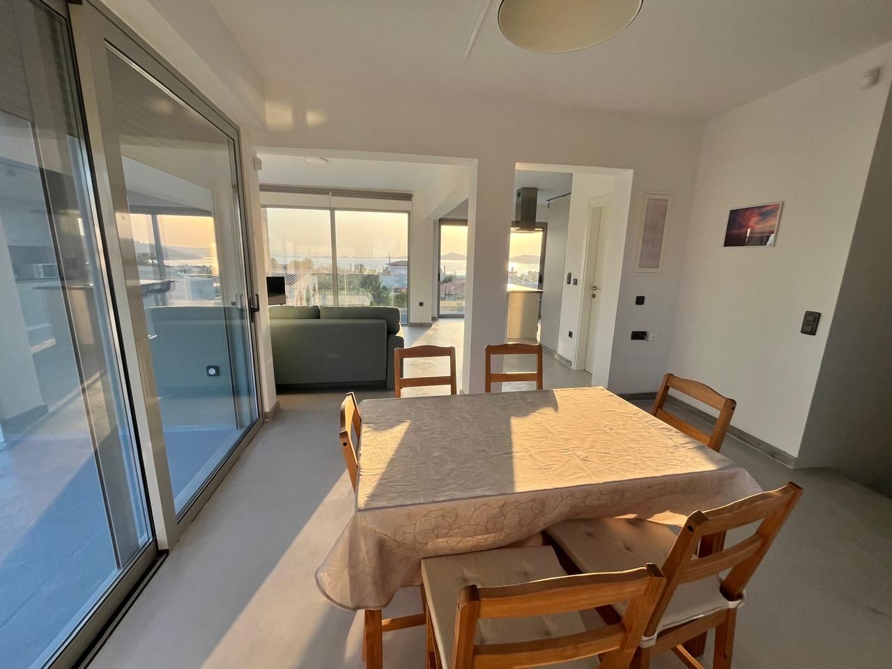 The dining table in the glazed corner, with views on two sides.