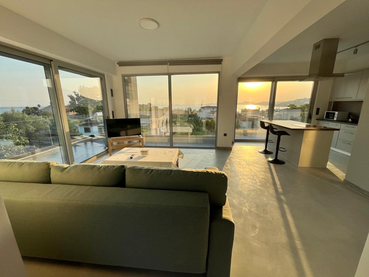 Looking across the living room to the kitchen bar as the sun sets.