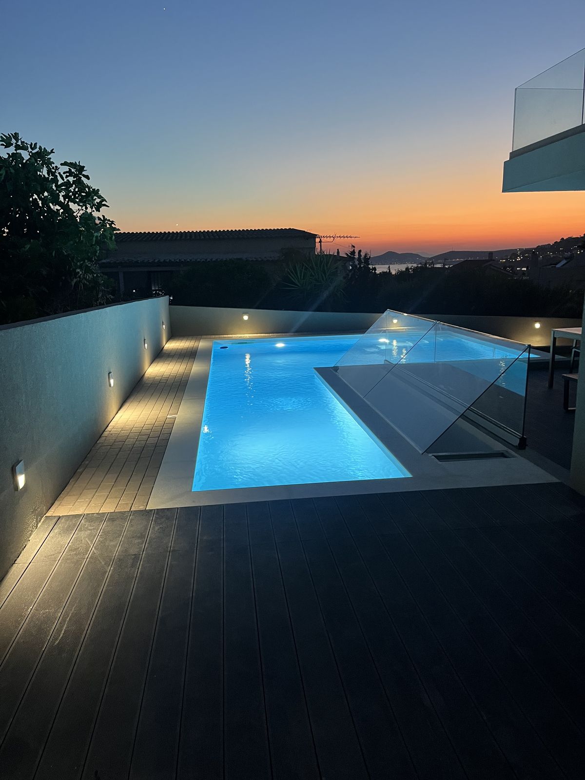The shared pool at dusk, the sunset burning out over the rooftops.