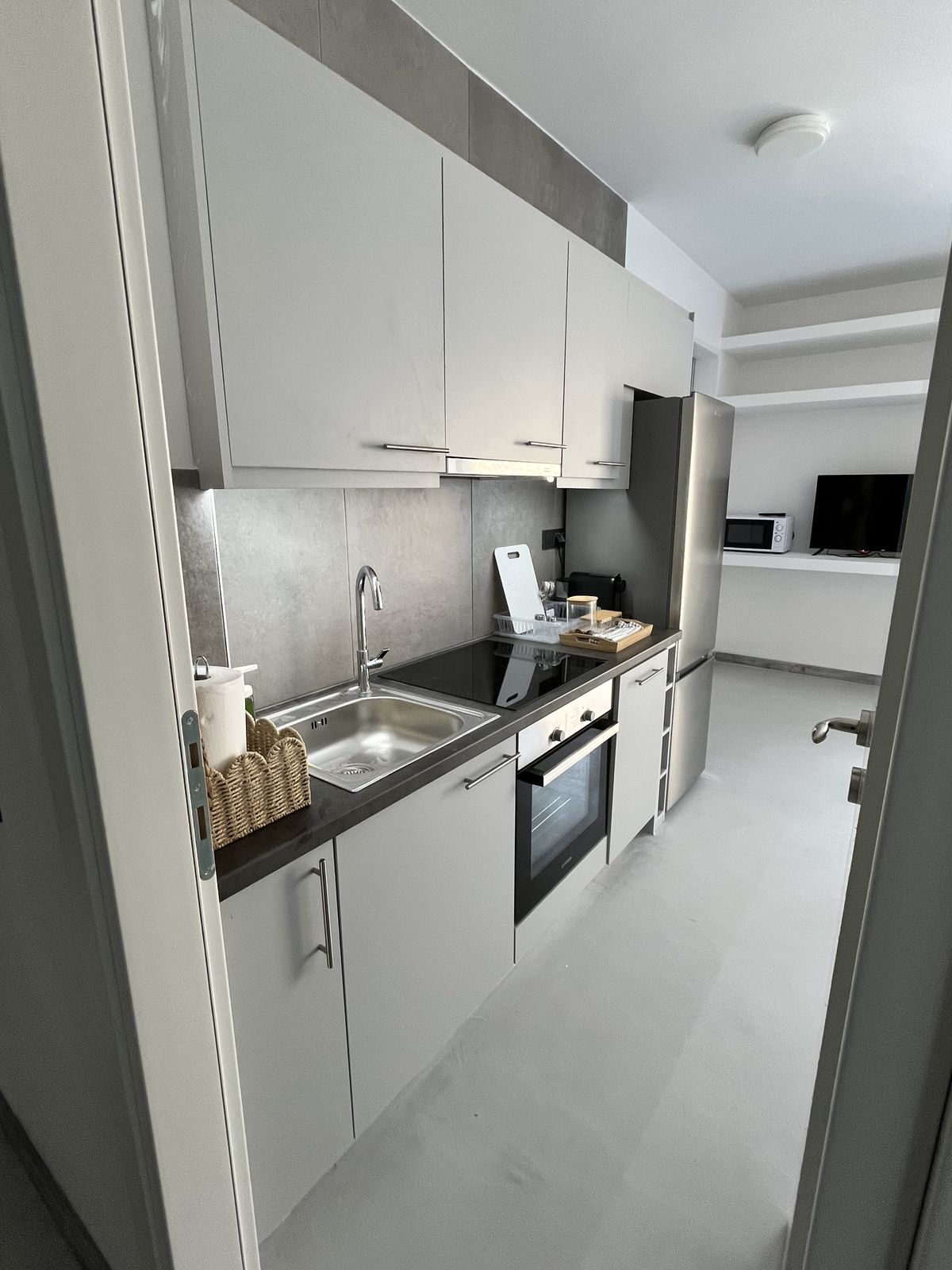 The kitchen, with oven, hob and full-height cupboards.
