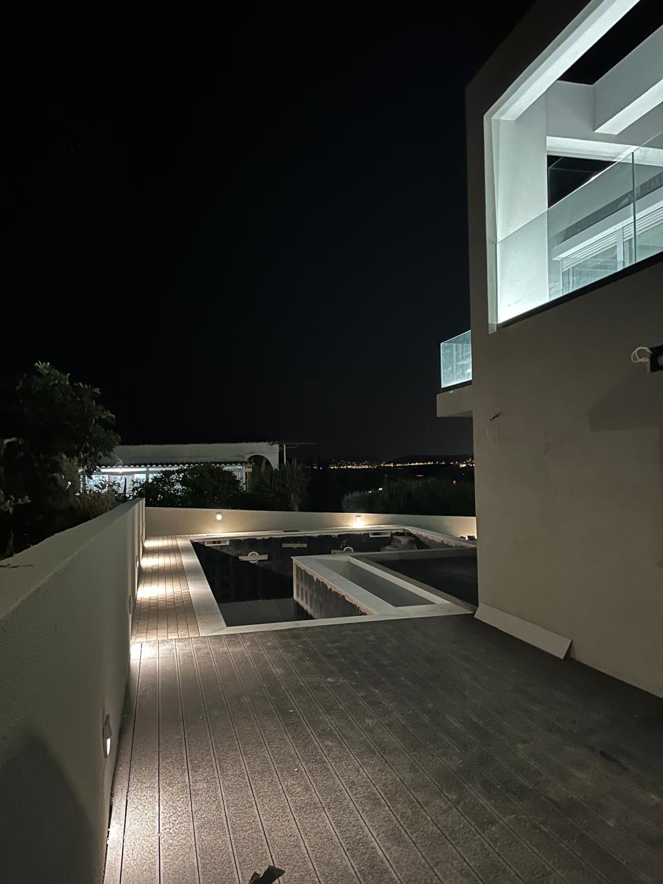 The pool and sea-view terrace of Blue Bay Dream B at twilight.